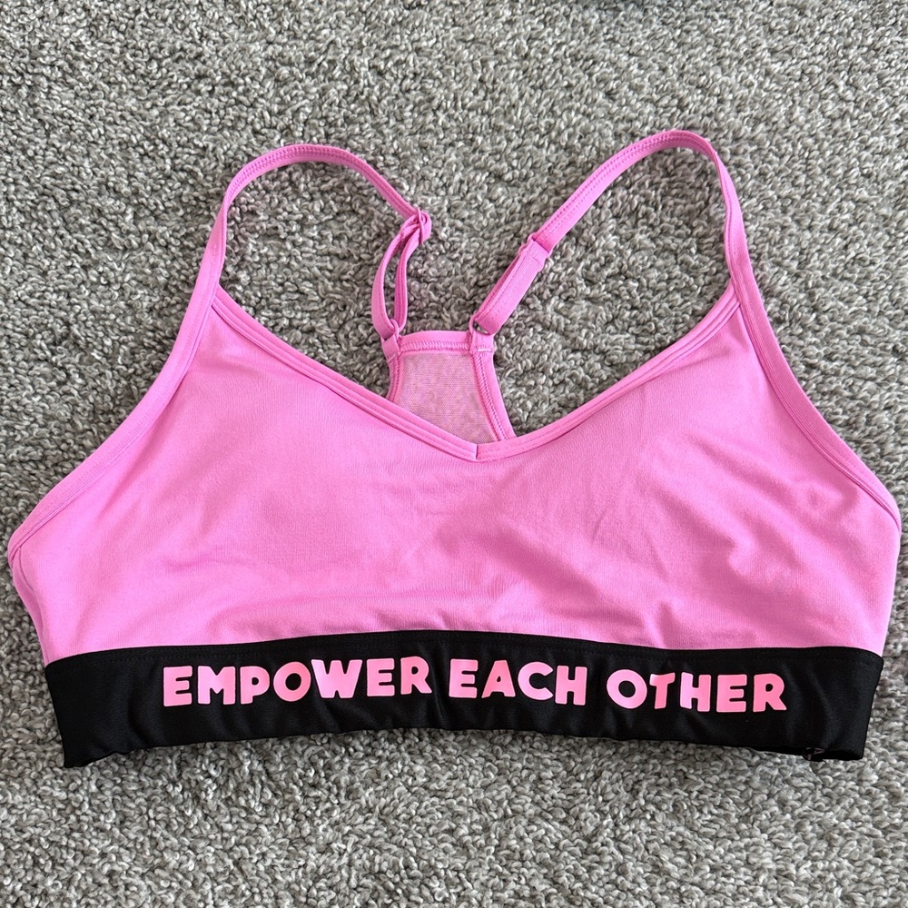 Pink sports bra with removable pads included. Size M.